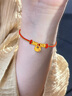 六桂福珠寶 LIU GUI FU JEWELRY盤纏黃金手鏈女1g足金福袋轉(zhuǎn)運珠編織紅手繩款手串畢業(yè)禮物送女友 足金盤纏福袋轉(zhuǎn)運珠手繩 0.91g 曬單實拍圖