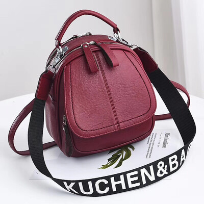 

A girl with a double shoulder bag a broadband shoulder bag a Korean version of a backpack a girl slanted a small round bag and