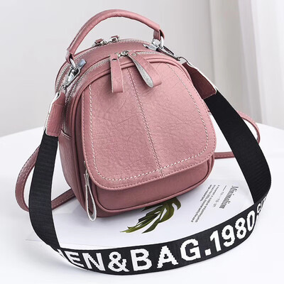 

A girl with a double shoulder bag a broadband shoulder bag a Korean version of a backpack a girl slanted a small round bag and