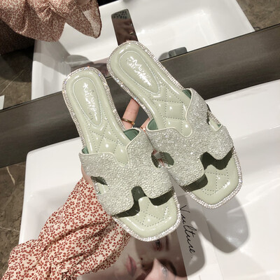 

Korean version of Baitao diamond H slippers for women wearing simple flat-soled recreational slippers outside the ins harbour in s
