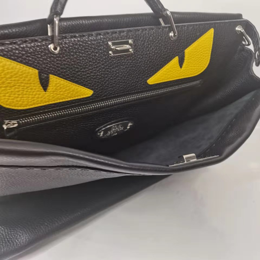 95新芬迪fendi黑色小怪兽恶魔黄眼睛斜挎手提包男包公文包配肩带