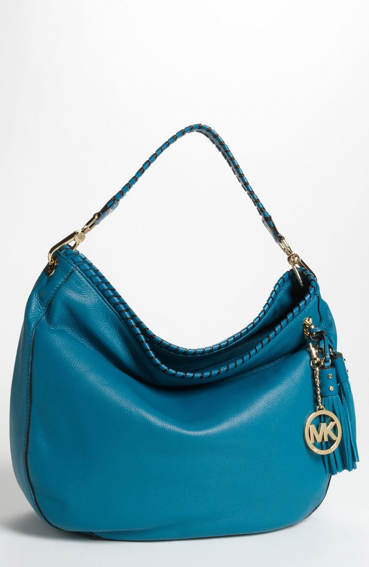 shoulder bag finished with a dangling logo medallion and swishy