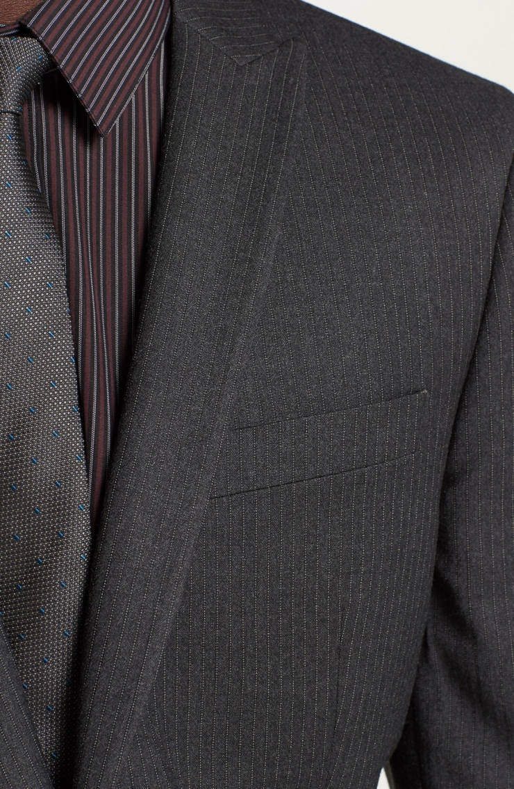 with narrow peak lapels and slim, neatly pressed flat-front