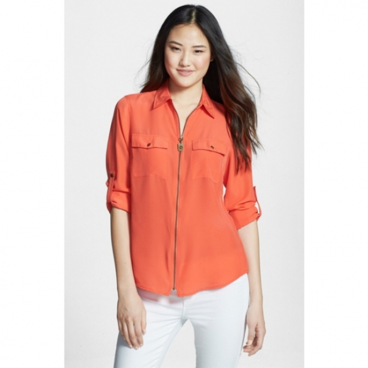 closes the front of a silky shirt styled with button-tab chest