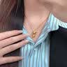 中国黄金（CHINA GOLD）黄金躲猫猫铃兰花喵吊坠女款足金首饰品情人节生日礼物送女友老婆 躲猫猫招财金喵项链【咖绳】约0.65g 实拍图